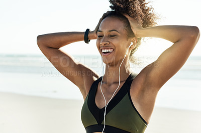 Buy stock photo Athlete, woman and rest with earphones at beach for fitness, listening to music and podcast. Female person, happiness and relief with playlist audio of exercise, sports training and marathon practice