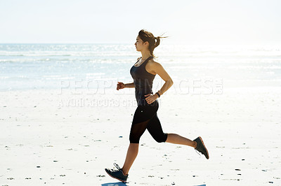 Buy stock photo Blue sky, fitness and running with woman on beach for cardio challenge or training routine. Exercise, ocean and speed with athlete or runner outdoor on sand for improvement, performance or workout