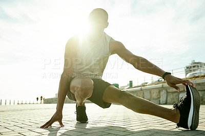 Buy stock photo Man, below and stretching legs for fitness, warm up and city for cardio preparation. Male person, urban street and athlete for workout, getting ready and exercise for marathon training with flare