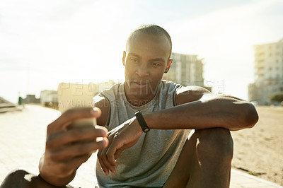 Buy stock photo Fitness, black man and relax with phone in city for running break, reading notifications and chat. Morning, athlete and resting with smartphone outdoor for cardio pause, social media and exercise app