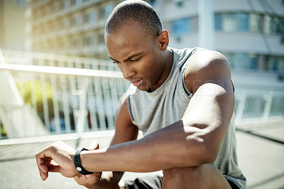 Buy stock photo Black man, smart watch and fitness on bridge in city, break or stopwatch for record, exercise and training. Person, runner and rest with clock, timer app or heart rate for cardio wellness in Nigeria
