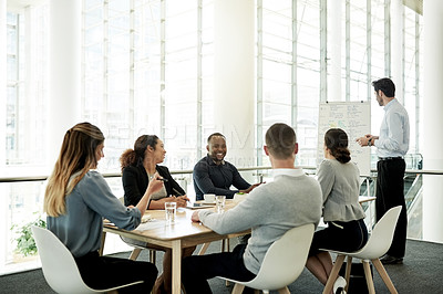 Buy stock photo Meeting, presentation and pitch with business man in office for whiteboard, timeline and project progress. Speaker, planning and schedule feedback with employees in agency for brainstorming proposal