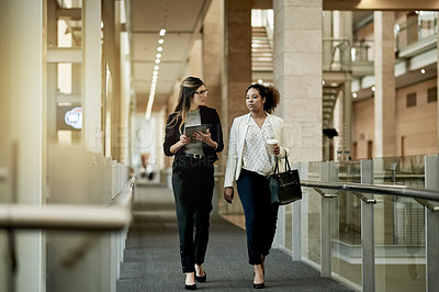 Buy stock photo Talk, team and business women walking in office with tablet for architecture or progress update. Discussion, meeting and architect in hallway for planning project, building or  development feedback
