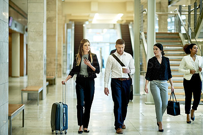 Buy stock photo Man, women and team on business trip at airport with luggage, smartphone and talk in lobby for travel. People, group and walk with chat, coffee and suitcase with mobile app for flight schedule