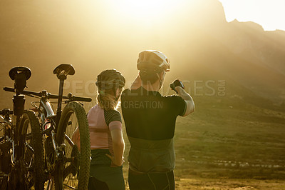 Buy stock photo Bike, couple and break for mountain view with pointing, cycling pause or sightseeing countryside. Sunrise, back of people or cyclist with rest from fitness training, cardio exercise and scenery space