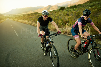 Buy stock photo Fitness, couple and cycling with bicycle in road for cardio exercise, triathlon practice and sport. Cyclist, space and people riding bike in countryside for marathon training, teamwork and endurance