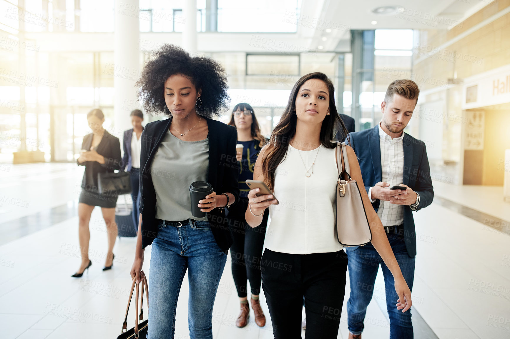 Buy stock photo Phone, commute or business people in office walking for corporate career, text message or diversity. Friends, women or group employees with mobile app in lobby of professional workplace in morning