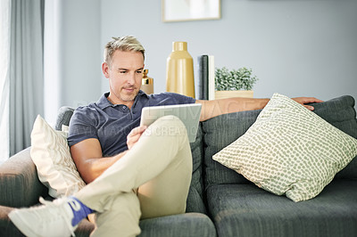Buy stock photo Tablet, show and relax with man on sofa for streaming service, connection and watching movie. Film subscription, entertainment and series browsing with person in living room of home for break