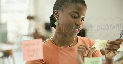 Buy stock photo Woman, office and sticky notes on glass, planning and logistics or strategy for company. Black person, entrepreneur and brainstorming for startup, project and mind map for idea or research for tasks