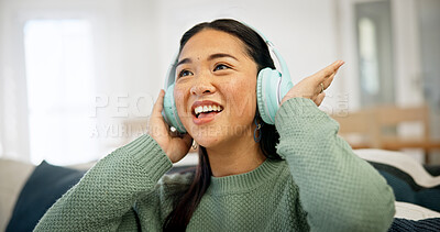 Buy stock photo Headphones, music or asian woman on sofa with audio streaming for podcast or entertainment in home. Happy, female person or subscription with smile, sound or network connection for weekend in house