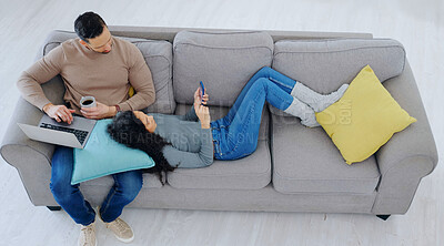 Buy stock photo Above, relax and couple on sofa with phone, laptop and talking for bonding on weekend break. Home, marriage and man with woman on cellphone, website or computer for internet, watching videos and rest