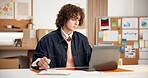 Man, laptop and notes in small business for logistics, order management and distribution schedule. Entrepreneur, writing and tech in office for inventory control, website update and stock checklist