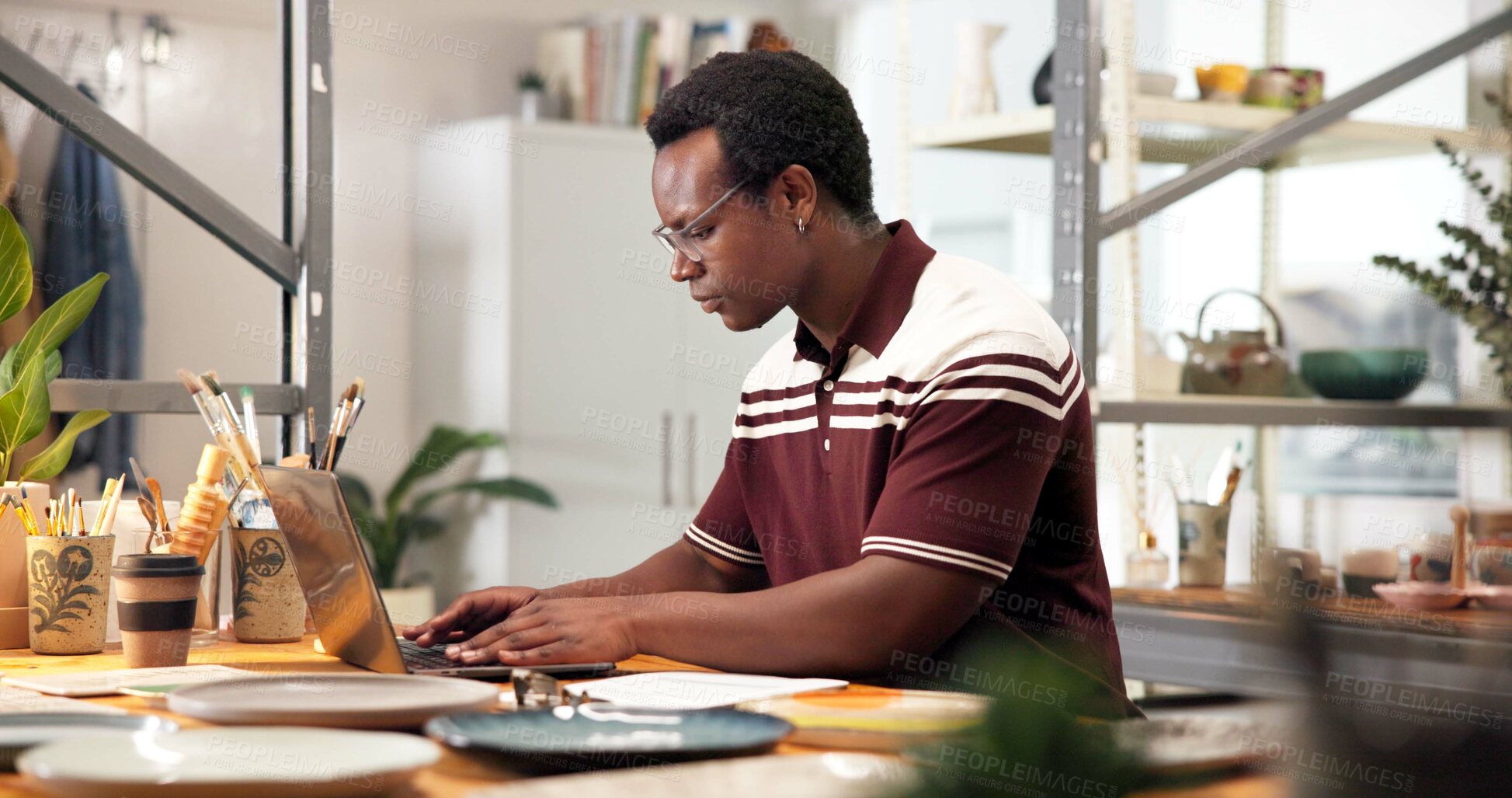 Buy stock photo Pottery, man and typing in small business with laptop, creativity and post art on ecommerce website. Entrepreneur, black person and update ceramics catalog in store with computer, online shop or app.