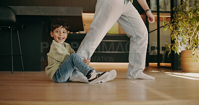 Buy stock photo Child, parent and clingy in home with legs, playful and dragging game for relationship development. Boy, person and family in living room with trust, bonding and smile for attachment and security