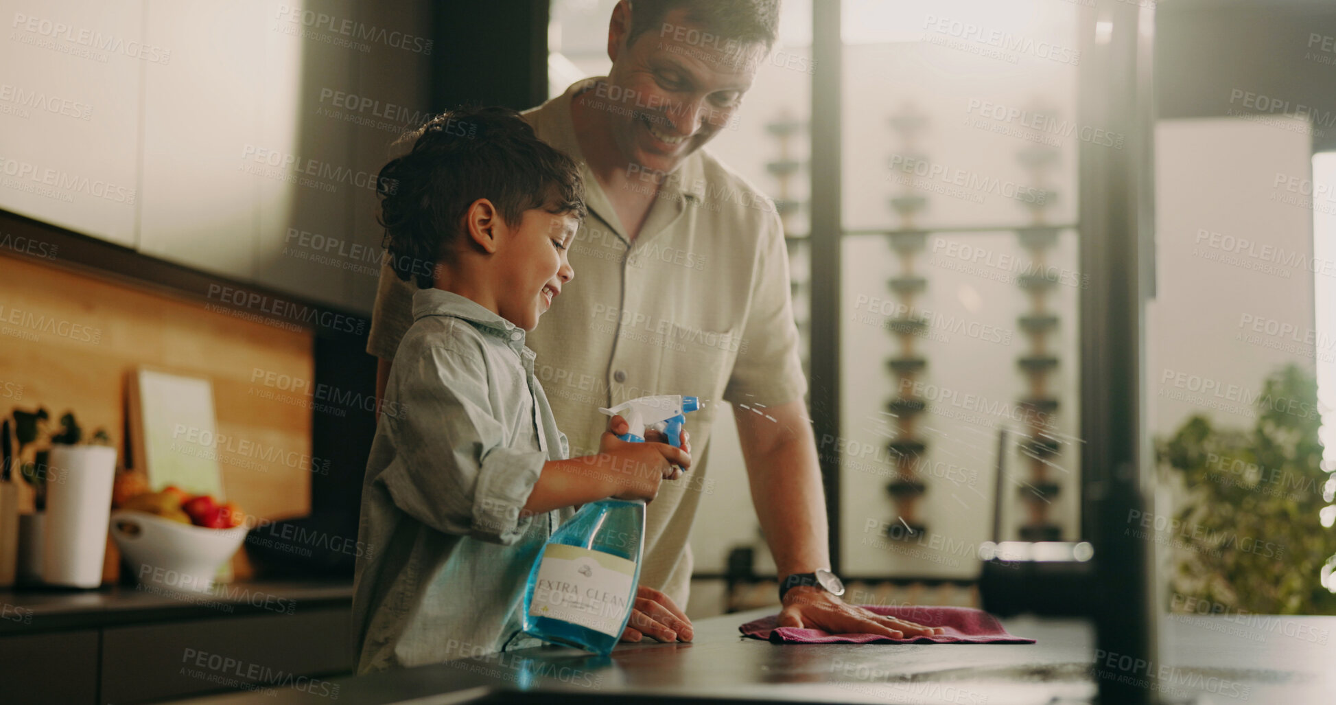 Buy stock photo Dad, kid and spray for cleaning, learning and teaching domestic duties with parenting in home. Hygiene, disinfect and man guiding son with detergent, wiping counter or help with kitchen cleanliness