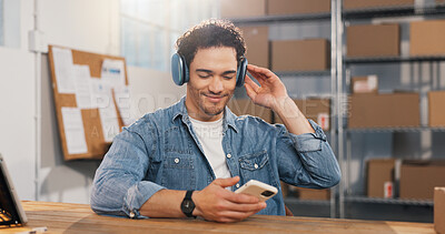 Buy stock photo Logistics, headphones and happy man with phone in small business, online or listen to music on break. Streaming, playlist and person with mobile, supply chain and relax with technology in startup