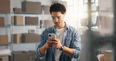 Buy stock photo Logistics, man and online in warehouse with phone, browsing and research courier price for shipping. Person, typing and ecommerce website with tech, check delivery cost and expenses for distribution.