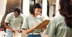 Checklist, volunteer or woman writing with clipboard for outreach, donation or charity campaign. Female person, activist or community service with notes for NGO project or outdoor fundraiser together