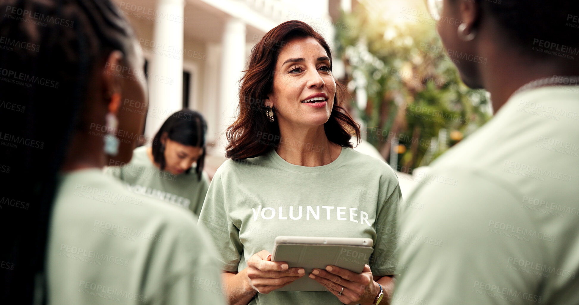Buy stock photo Volunteer, team leader and tablet outdoor for planning event, task delegation and charity agenda. NGO, happy mature woman and tech for group coordination, fundraising schedule and outreach management