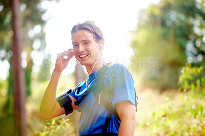 Buy stock photo Fitness, music and man outdoor for exercise, workout and streaming motivation podcast. Earphones, runner and happy person in nature with audio, sound and listening to sports playlist for training