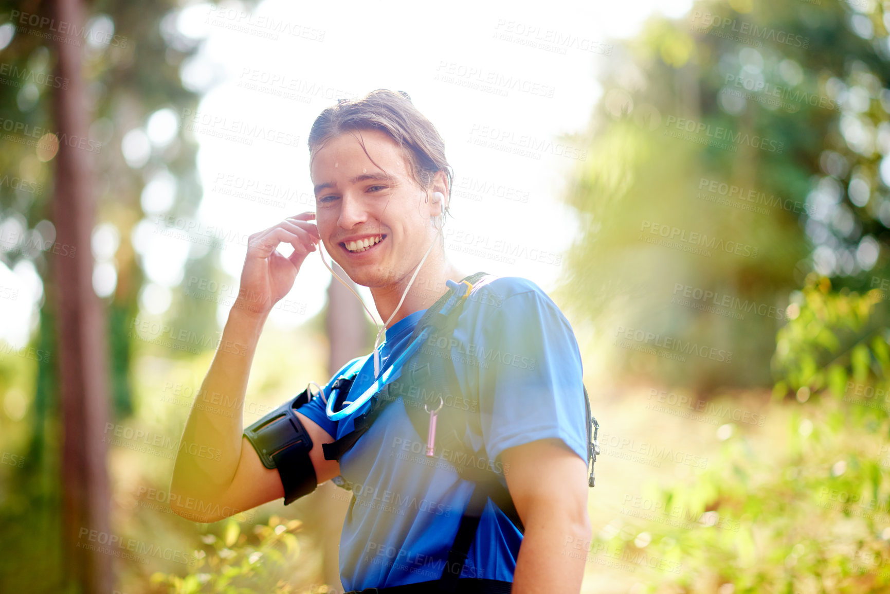 Buy stock photo Fitness, music and man outdoor for exercise, workout and streaming motivation podcast. Earphones, runner and happy person in nature with audio, sound and listening to sports playlist for training