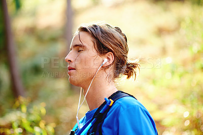 Buy stock photo Fitness, forest and man with earphones in nature for exercise, cardio workout and training. Relax, rest and person listening to music, audio and playlist outdoor for wellness, health and sports