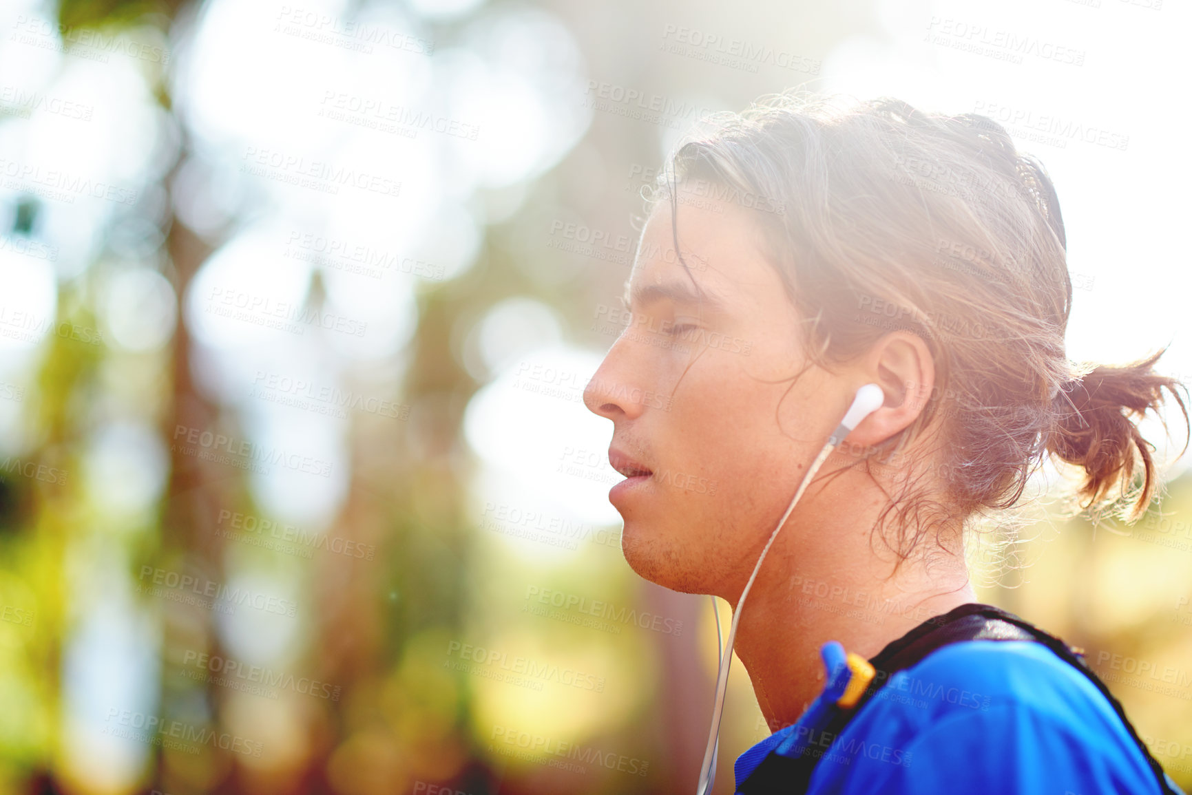 Buy stock photo Breathing, runner and man in woods with fitness, music and  with health, challenge and workout, Relax, profile or exhausted athlete with wellness, earphones or nature with break, space and exercise