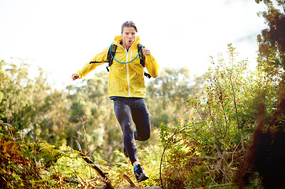 Buy stock photo Athlete, man and running for fitness in woods with exercise, training and cardio workout in forest. Male person, jump and endurance for marathon practice, sports performance and challenge of wellness