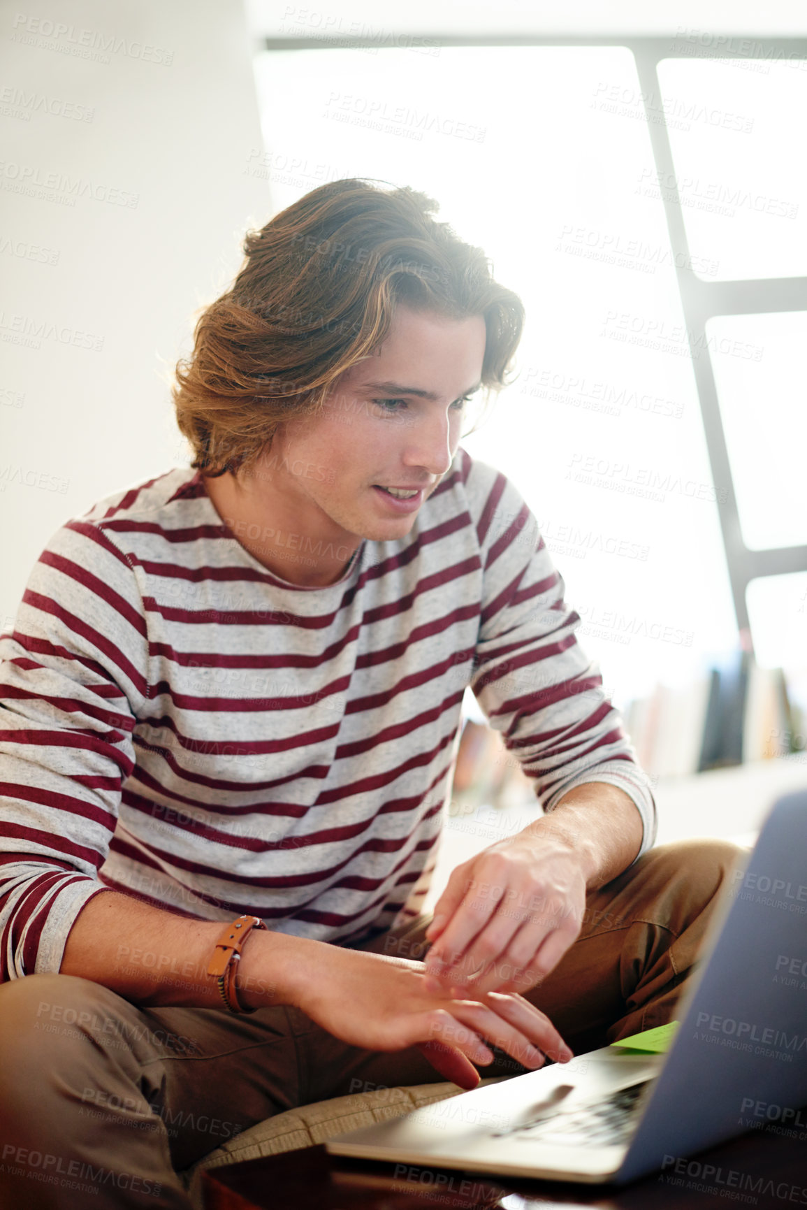 Buy stock photo Man, student and laptop on sofa, research and home with online course, knowledge or assessment. Person, scroll and elearning on couch with computer, study or scholarship with college project at house