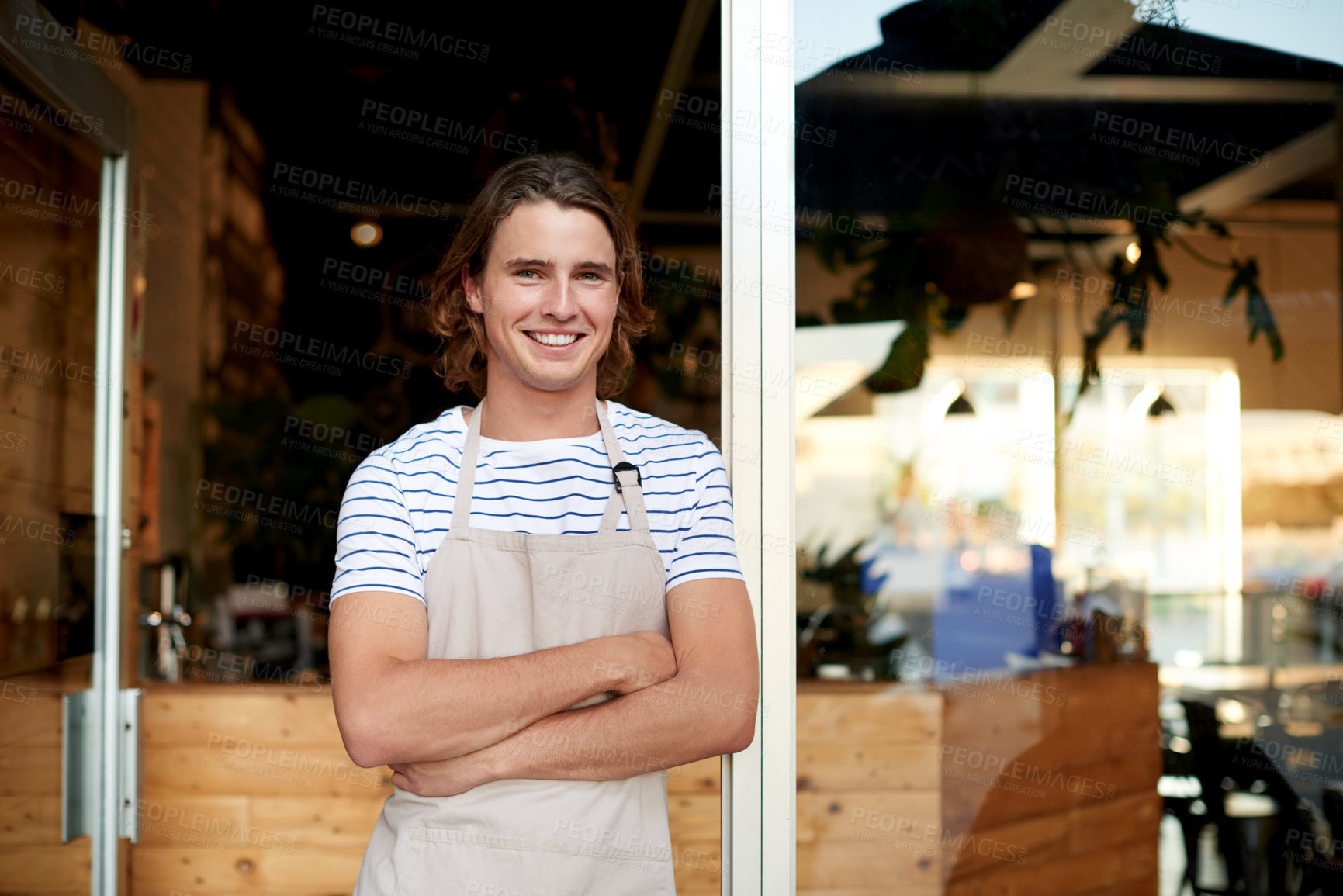 Buy stock photo Portrait, waiter and man with arms crossed, cafe and pride for hospitality, apron or small business. Happy, employee and person with smile at entrance, welcome or confident for coffee shop in USA