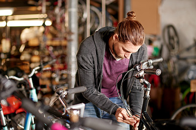 Buy stock photo Business, bicycle and man in workshop, tools and fix with skills, startup and repair brakes. Shop owner, entrepreneur or employee with inspection, store or cyclist with maintenance or engineer
