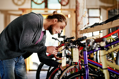 Buy stock photo Bicycle, maintenance and man in shop, entrepreneur and repair of eco friendly transport and service. Technician, inspection and person with bike, fixing or confident for small business or garage