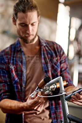 Buy stock photo Man, bike and repair brakes at workshop with thinking, equipment and problem solving at small business. Person, technician and bicycle mechanic with cable, safety check and inspection at garage