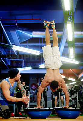 Buy stock photo Fitness, athlete or handstand on bosu ball at gym with instructor applause, core strength or balance. Low angle, personal trainer or man with workout for muscle development, technique help and night