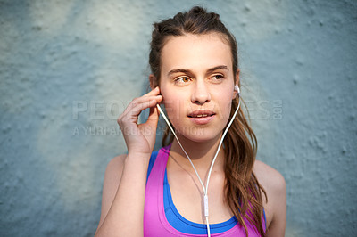 Buy stock photo Teenager, girl and earphones for fitness with music, podcast and training break by wall. Person, headphones and streaming audio for sport exercise, workout playlist and marathon practice for health