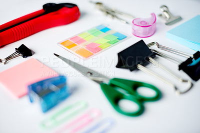 Buy stock photo Business, flat lay and stationery on desk of workstation, ready for creative planning or design. Scissors, sticky notes and utility knife on table in empty office for productivity process from above