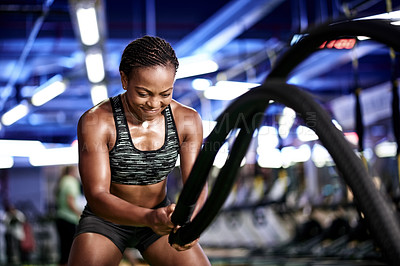 Buy stock photo Battle ropes, strong and black woman in gym for exercise, bodybuilder workout and training. Sports, fitness and person with muscle strength, endurance and equipment for wellness, health and challenge