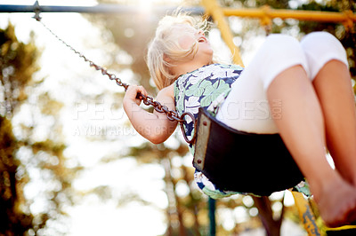 Buy stock photo Happy, below and girl in park on swing set, having fun and playful on summer break. Smile, freedom and child in playground with sunshine, safety and childhood development in springtime getaway. 