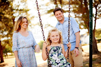 Buy stock photo Parents, child and portrait on swing at park for playing together, freedom and holiday activity. Family, people and happy on playground equipment for bonding, sensory stimulation and childhood memory