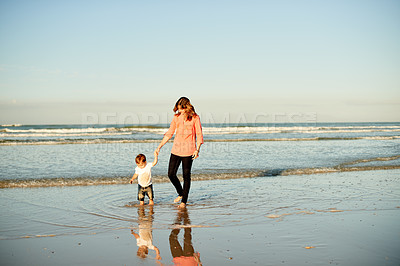 Buy stock photo Holding hands, walking and mom with kid at beach for bonding, summer vacation and holiday together. Family, space and mother with child in waves, ocean and seaside for fun, trip and weekend outdoor
