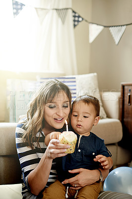 Buy stock photo Birthday, celebration or cupcake with mom and son in living room of home together for party. Candle, dessert or milestone with boy child and single parent woman in apartment for development or growth