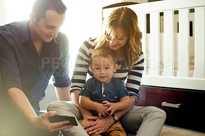 Buy stock photo Parents, movie or baby with phone in family house for streaming videos or bonding together. Smile, father or mom with child in home for watching cartoons, growth development or support with mobile