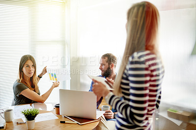 Buy stock photo Woman, meeting and tech at startup with discussion, documents and review charts at media company. People, team and planning with graphs, feedback and talk with web traffic stats at creative agency