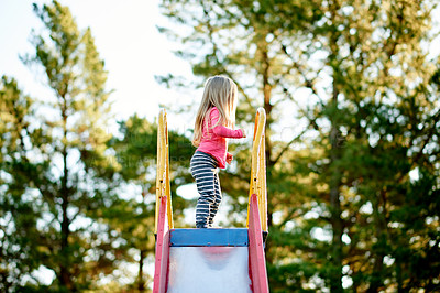 Buy stock photo Nature, slide and child in park for holiday, weekend or vacation by trees for fun. Smile, activity and girl kid for playing outdoor on playground for hobby on equipment in summer in backyard.