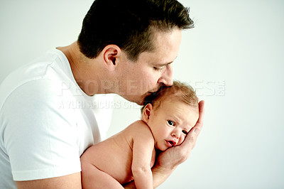 Buy stock photo Love, kiss and dad with baby in home for healthy relationship, bonding and care in morning. Family, house and newborn with father with affection, embrace and trust for connection, safety and support