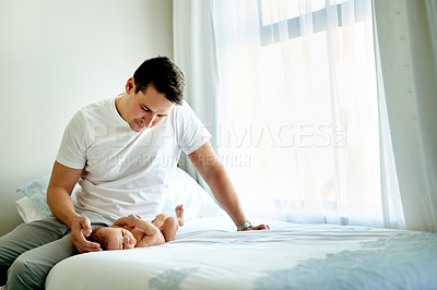 Buy stock photo Father, baby and happy on bed in home for love, touch or bonding with play in morning. People, dad and newborn son with smile, connection and affection with infant child in nursery at family house