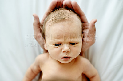 Buy stock photo Baby, newborn and hands of parent in nursery with bonding, frown or serious face with head support in family house. People, early child development and connection, scowl or grumpy infant in home