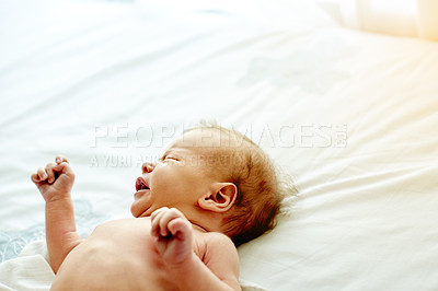Buy stock photo Sad baby, crying or bed with sheet on duvet for nap time, rest or snooze on space in home. Newborn, child or kid asleep with eyes closed or emotion on fabric for youth or peaceful slumber in house