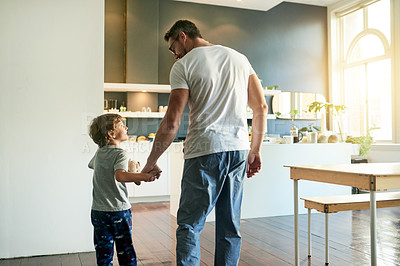 Buy stock photo Back, home and father with boy, holding hands and start day with routine, help and talking. Apartment, happy family and parent with support, dad and child development with discussion and morning