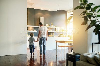 Buy stock photo Back, father and son walking in home holding hands for morning bonding, breakfast and waking up. Love, caring man and child in kitchen space for skills development, care or support in relationship